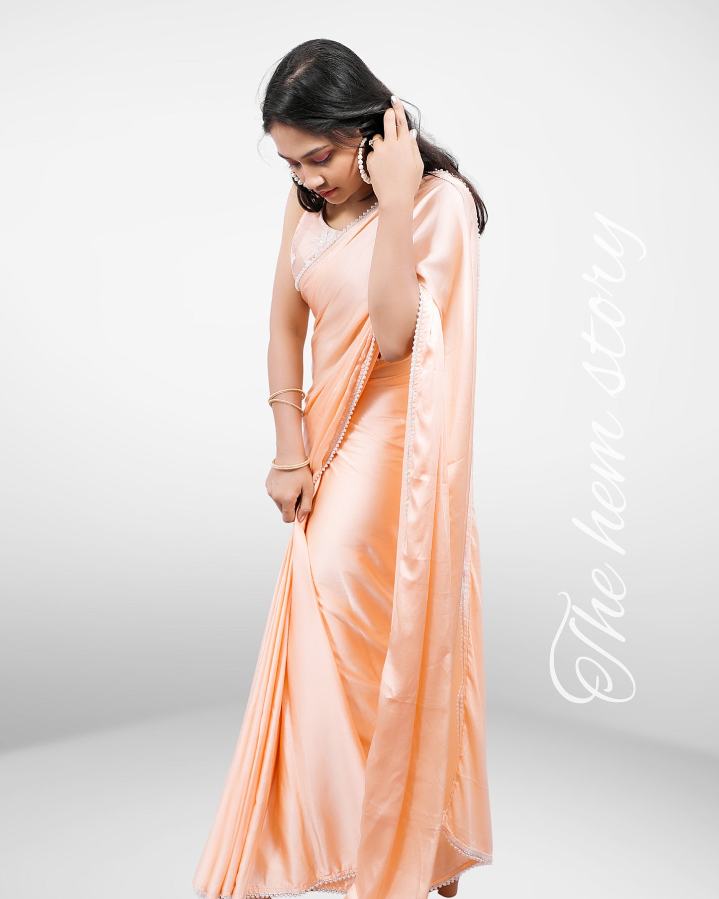 JASHN -Pastel Orange Satin Saree With Inticate Pearl Borders