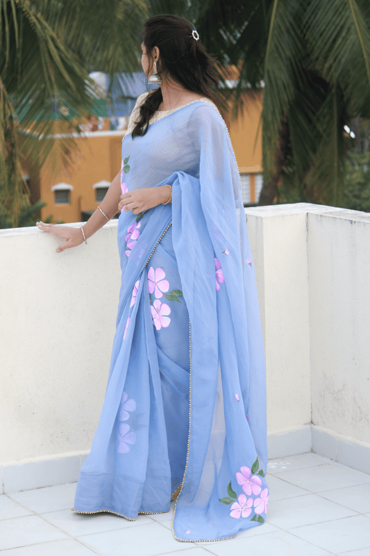 CHITRAKARI- Powder Blue Handpainted Organza Saree Enhanced with Pearl Borders